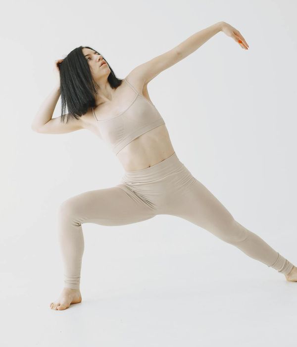 Woman in a calm yoga pose, embodying gentle movement and focus.